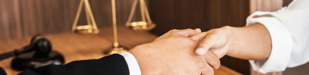 Lawyer consultant shaking hand with client in law firm