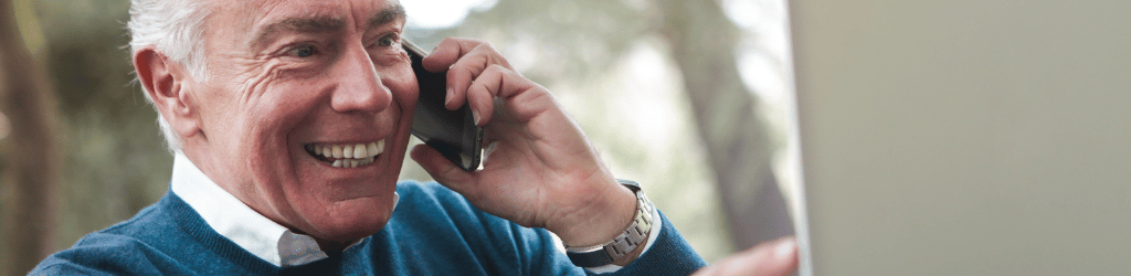 Man with a large smile using phone.