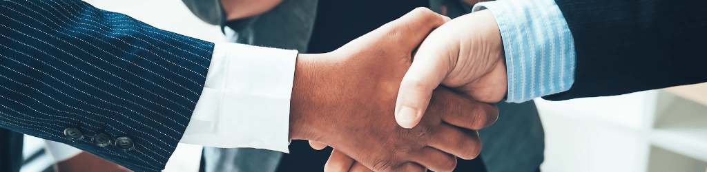 Lawyer and client celebrating a commitment to each other with a handshake,