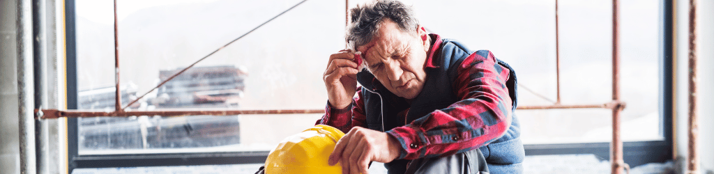 INjured worker with wound on head, after an accident on the construction site.