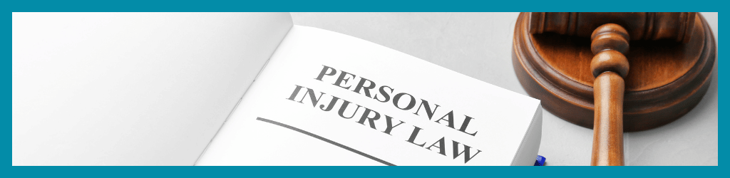 A book on a desk titled 'Personal Injury Law', with a gavel next to it.