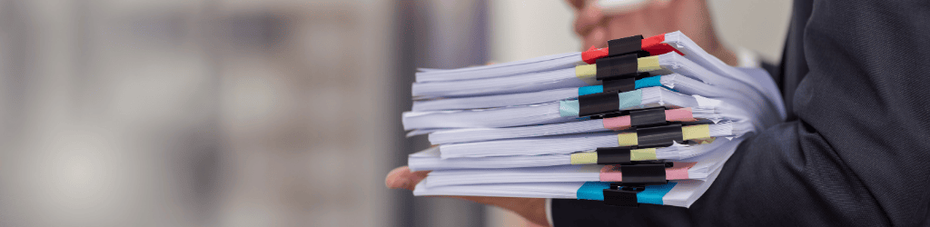 legal employee working with documents at the table workplace, closeup