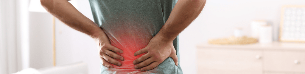 Man Suffering from Back Pain at Home. Bad Posture Problem